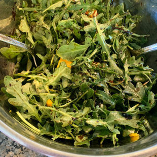 arugula and mangoes in a bowl