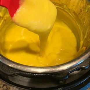 dal dripping off from a spatula showing it's paste like consistency