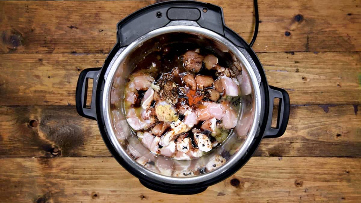 Garlic ginger, honey, sauces, vinegar, chilli flakes, salt, pepper, stock added to chicken.